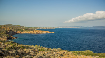 beautiful nature scenery landscape of cape on Mediterranean sea with rocks above water and waves in warm summer weather and clean sky