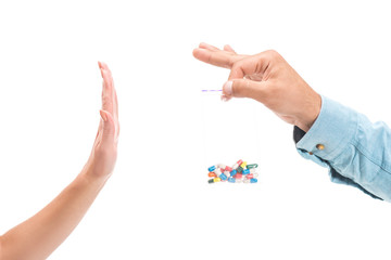 cropped image of girl rejecting unhealthy drug pills and showing stop sign to man isolated on white
