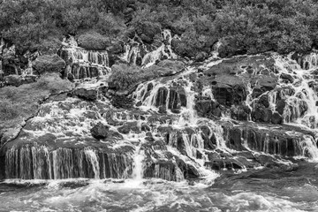 Hraunfossar series of waterfalls formed by rivulets streaming over a distance of about 900 metres....