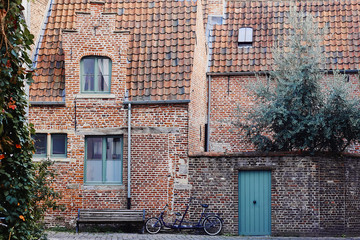 Traditional medieval architecture, old brick house with red tiled roof