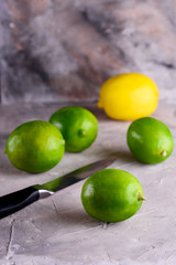 Juicy and fragrant lemons. Green and yellow lemons on a concrete background. Lemons on a blue background.