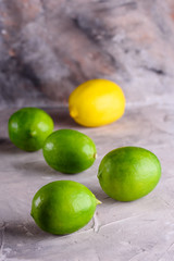Juicy and fragrant lemons. Green and yellow lemons on a concrete background. Lemons on a blue background.