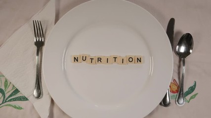 Animation with letters on a dinner plate forming the word NUTRITION.
