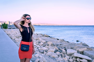 Woman enjoying the summer sunset portrait Limassol, Cyrpus. Sea view. Vintage styles