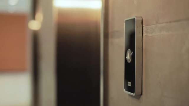 Close up hand young businessman presses a button of lift to go up by a finger elevator business technology lift push building interior down choice control office open door