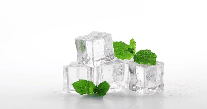 mint with ice cubes on white. dolly shot