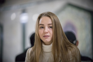 Portrait of beautiful young woman in the subway. Looking in the camera