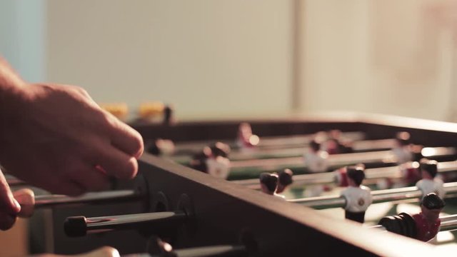 Close up hand man table football game miniature recreation grass color attack fun soccer competition player teamwork entertainment plastic ball goal toy play sport field team green kicker match