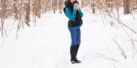 Fototapeta na wymiar Close up of beautiful young woman walking in the winter snowy nature
