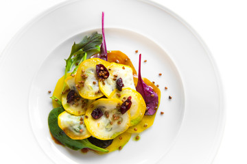 salad plate with yellow beetroot, lambs lettuce, red leaf lettuce, arugula, cranberries and seeds