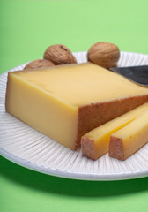 Piece of aged Comte or Gruyere de Comte, AOC French cheese made from unpasteurized cow's milk in the Franche-Comte region of eastern France with traditional methods of production.