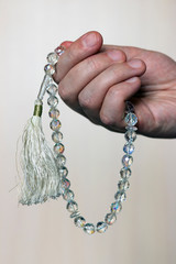 Hand with crystal islamic beads (tasbih)