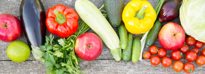 Set of raw organic fruits and vegetables on rustic wooden background. Close-up. Top view. From above, flat lay, overhead.