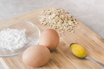 Fototapeta na wymiar Raw oatmeal with ingredients honey and egg