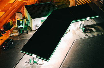 Top down high perspective view of unidentifitable gas or petrol station at night