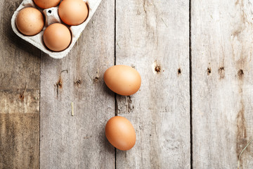 chicken eggs on a wooden background