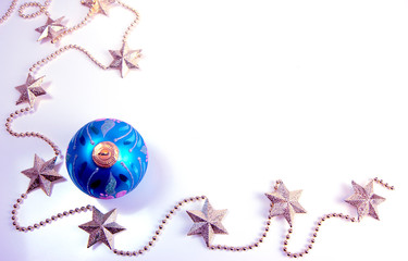 Blue glass ball for Christmas tree decoration and golden stars. Christmas and New Year holiday background concept. Copy space for text.