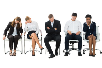 Group Of Businesspeople Sleeping On Chair