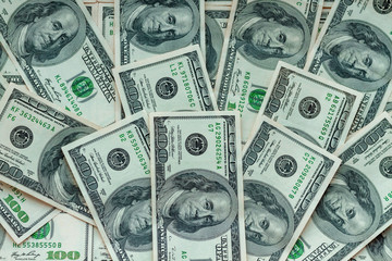 Background for design from a lot of green money. Many banknotes laid out on the table. More than two thousand dollars laid out as a background for a design in green tones.