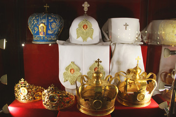 Crown and priests hats on a red background