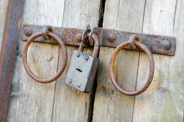 Old rusted lock on  huge wooden doors