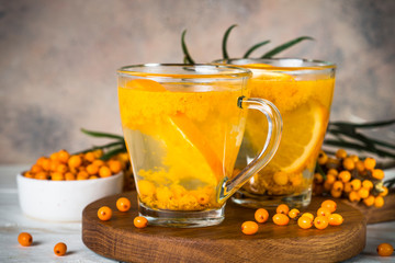 Sea buckthorn tea with orange in a glass cups.