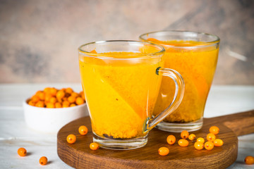 Sea buckthorn tea with orange in a glass cups.