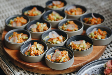 salmon Tartar with avocado in small plates for Banquet.
