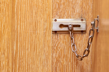 metal chain lock on the wooden front door