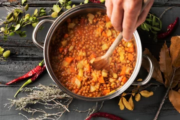 Foto op Plexiglas man preparing a vegetarian lentil stew © nito