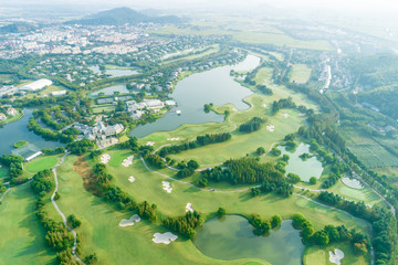 Aerial photograph of forest and golf course with lake