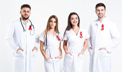 Group of doctors  with watercolor of red ribbon .world AIDS day concept. On the white background.