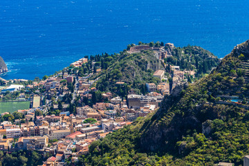 Fototapeta na wymiar The view from the small village Castelmola at mountain top above Taormina, with the view of Mediterranean Sea and the skyline of Taormina.