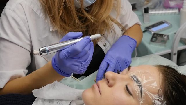 professional eyebrow permanent makeup. close-up brows tattoo. slow motion