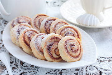 Cottage cheese cookies - snails with cinnamon, selective focus