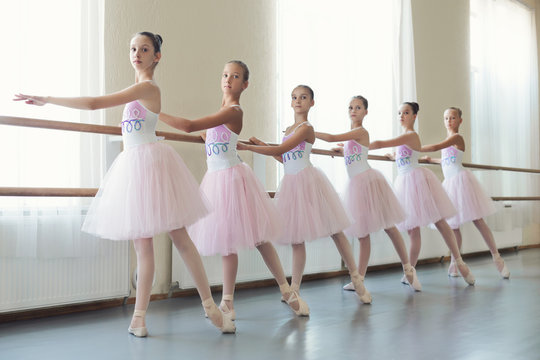 Group of young ballerinas training choreography, copy space