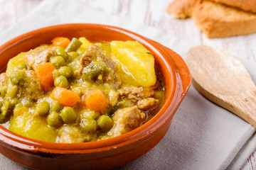 Spanish stew made with potato, meat, carrots, green peas and rustic herbs.