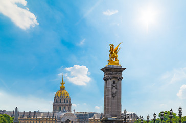 Sun shining over Pegasus golden statue on Alexander III bridge and Army museum