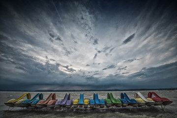 Paddle boats in the dock on Lake Balaton with cloudy sky