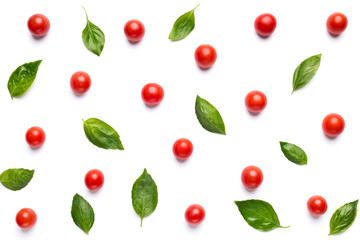 Colorful pattern of tomatoes and basil leaves on white background