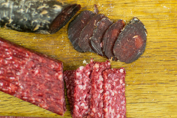Smoked sausages are cut on a cutting board.