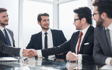handshake of business partners at a meeting in the office