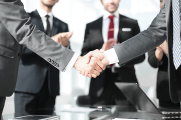 handshake of financial partners in the office