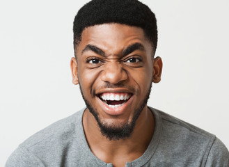 Obraz premium Happy african-american man grimacing at camera closeup
