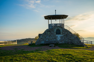 Germany, Pavillon and benches on green meadow of black forest mountain kandel summit