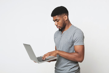 Pensive african-american man looking at his laptop