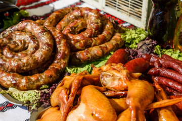 Homemade sausage on the green lettuce leaves