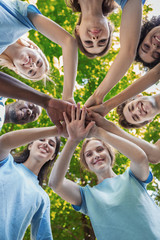 Group of happy volunteers collaborate at park