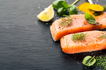 Raw salmon fish on black slate