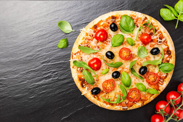 Top view of fresh appetizing pizza on dark